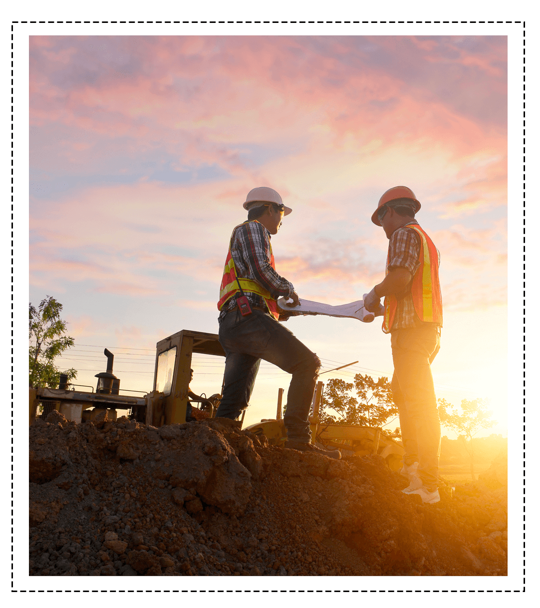 two construction workers standing in the sunlight working